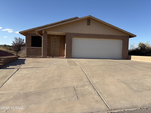 829 E Calle Esplendor, Nogales, AZ 85621 - ranch-style home featuring an attached garage, driveway, and brick siding