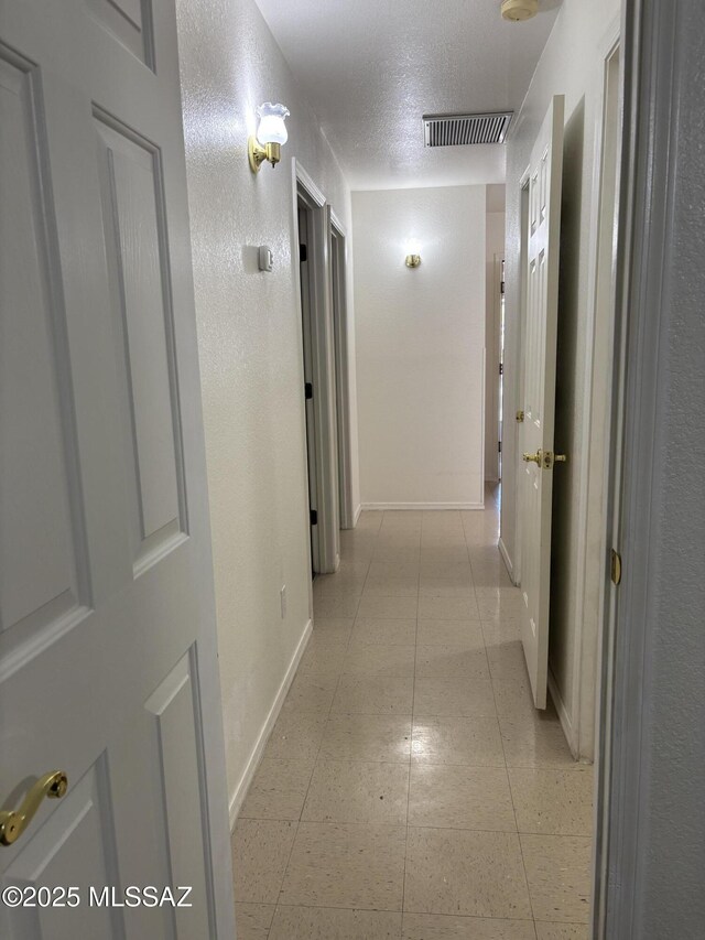 829 E Calle Esplendor, Nogales, AZ 85621 - corridor featuring light tile patterned floors, baseboards, a textured ceiling, and visible vents