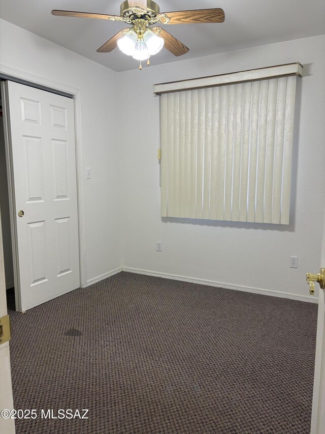 829 E Calle Esplendor, Nogales, AZ 85621 - unfurnished room with ceiling fan, baseboards, and dark colored carpet