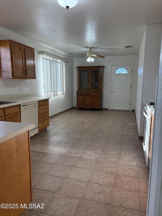 829 E Calle Esplendor, Nogales, AZ 85621 - kitchen with visible vents, white appliances, ceiling fan, light countertops, and a textured ceiling
