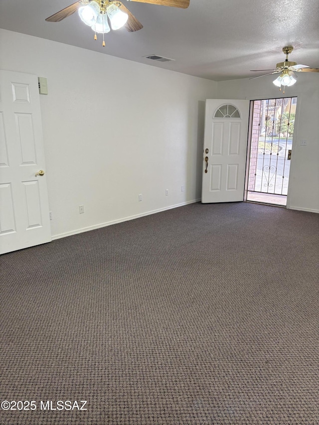 829 E Calle Esplendor, Nogales, AZ 85621 - unfurnished room with baseboards, ceiling fan, and dark colored carpet
