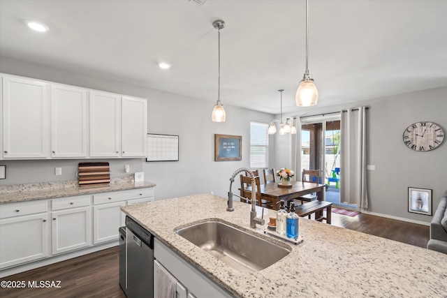 kitchen featuring pendant lighting, dishwasher, a sink, white cabinetry, and dark wood-type flooring