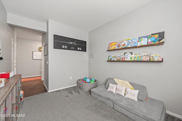 sitting room with baseboards and carpet