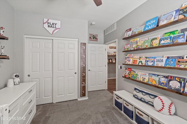 interior space with carpet floors, ceiling fan, and visible vents
