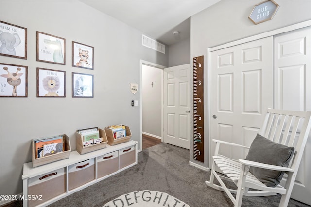 interior space with visible vents and dark colored carpet