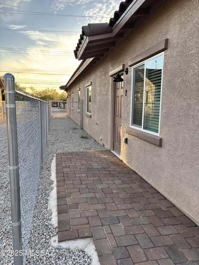 3649 S Belmar Ave, Tucson, AZ 85713 - view of property exterior with stucco siding, a fenced backyard, a patio, and a tile roof