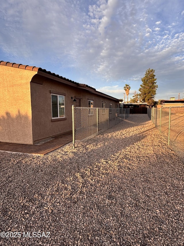 3649 S Belmar Ave, Tucson, AZ 85713 - view of side of property with stucco siding, fence, and a tiled roof