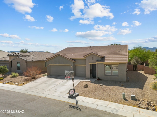 ranch-style home with driveway, a tile roof, a garage, fence, and stucco siding