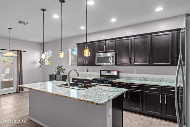 1020 E Wiley Squirrel Ln, Sahuarita, AZ 85629 - kitchen featuring visible vents, pendant lighting, light stone counters, a sink, and stainless steel appliances