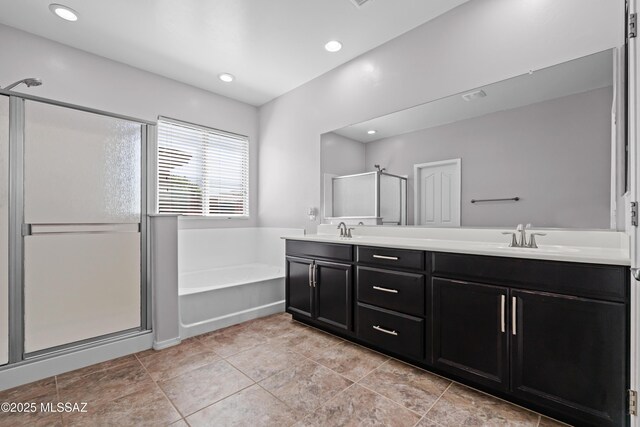 1020 E Wiley Squirrel Ln, Sahuarita, AZ 85629 - full bath featuring a garden tub, a sink, a stall shower, and double vanity