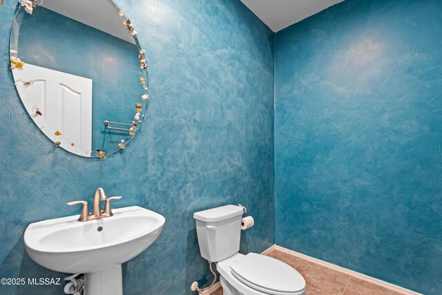 1020 E Wiley Squirrel Ln, Sahuarita, AZ 85629 - bathroom featuring a sink, baseboards, tile patterned flooring, and toilet