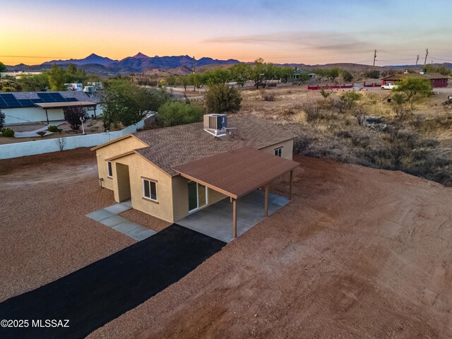 1153 Escorpion Ct, Rio Rico, AZ 85648 - aerial view at dusk with a mountain view
