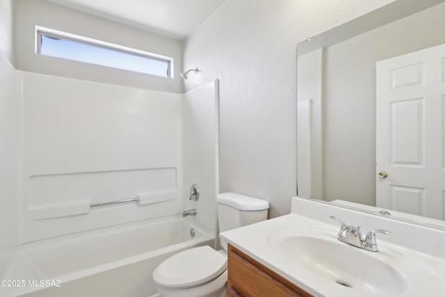 full bath featuring washtub / shower combination, a textured wall, vanity, and toilet