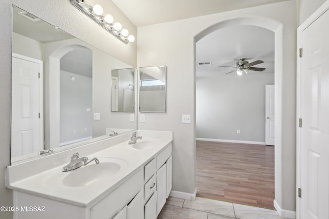 bathroom featuring a ceiling fan, baseboards, visible vents, and a sink