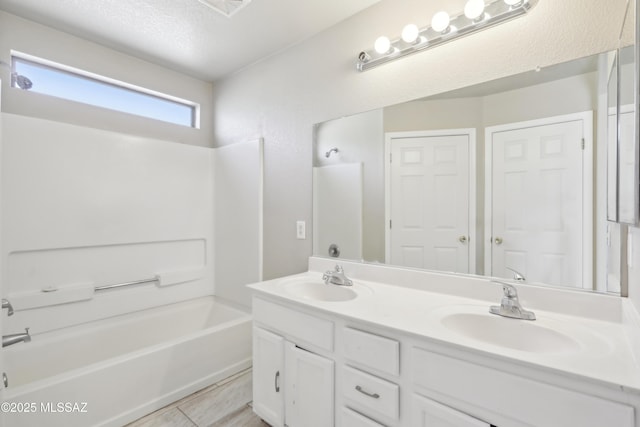 7351 S Bass Ave, Tucson, AZ 85746 - bathroom with double vanity,  shower combination, tile patterned floors, and a textured ceiling