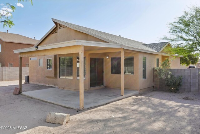 7351 S Bass Ave, Tucson, AZ 85746 - back of house featuring a trampoline, a patio area, and stucco siding