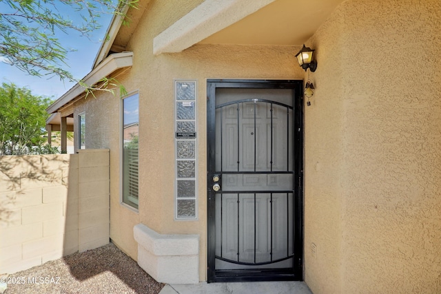doorway to property with stucco siding