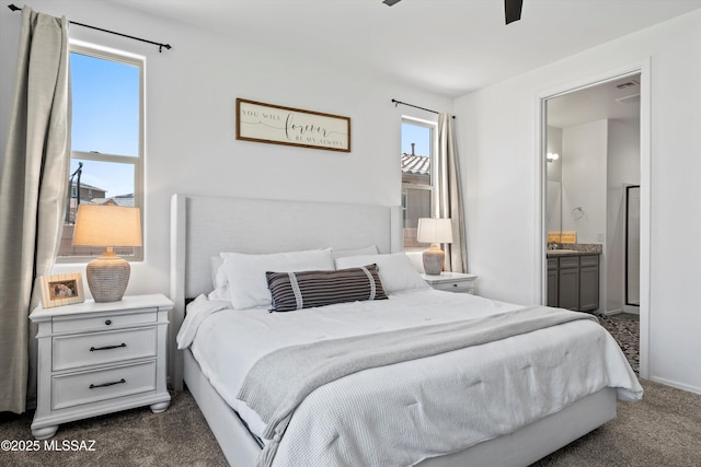 bedroom featuring dark colored carpet and connected bathroom