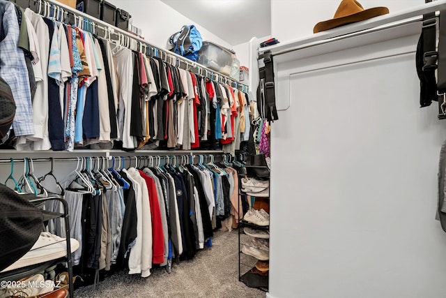 walk in closet with carpet floors
