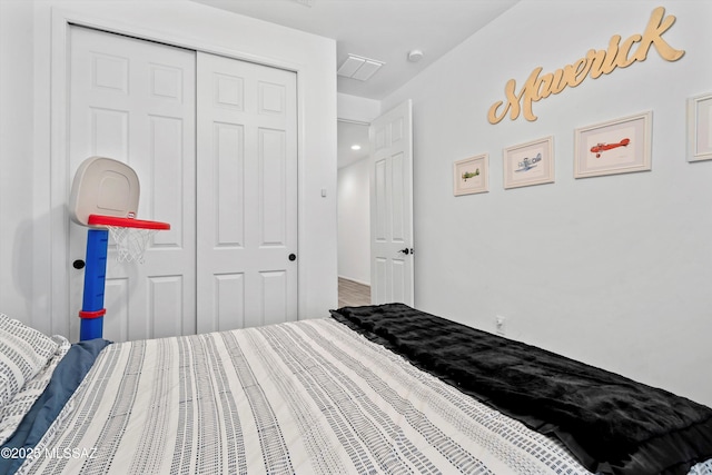 bedroom featuring visible vents and a closet