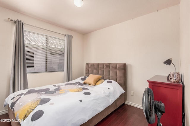 bedroom featuring wood finished floors and baseboards
