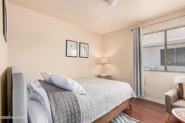 bedroom with baseboards and wood finished floors