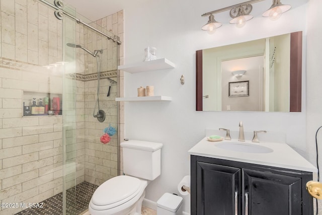 full bathroom with a stall shower, toilet, and vanity