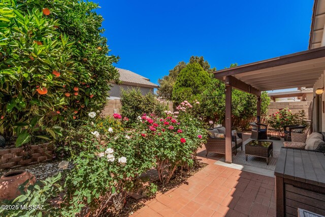 view of patio / terrace featuring an outdoor hangout area and a fenced backyard
