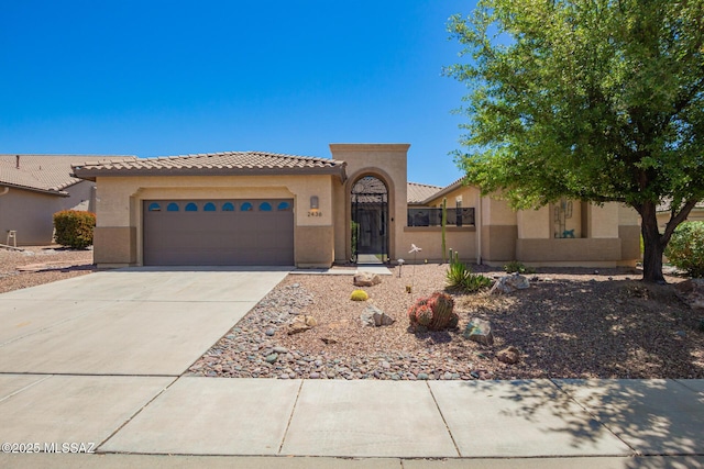 2436 E Desert Pueblo Pass, Green Valley, AZ 85614 - mediterranean / spanish home with a garage, stucco siding, driveway, and a tile roof