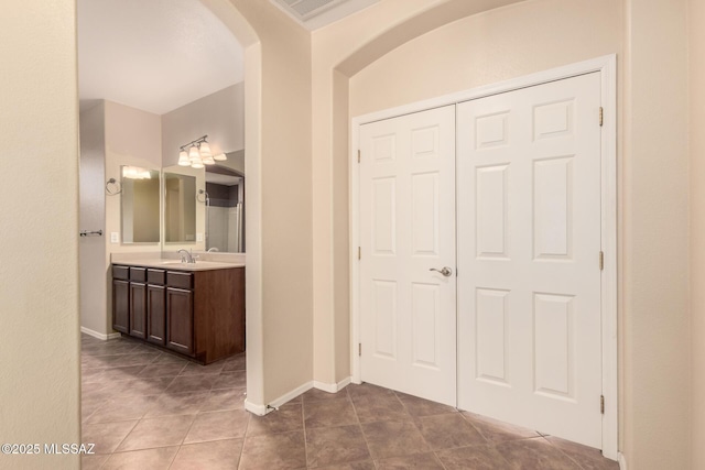 2436 E Desert Pueblo Pass, Green Valley, AZ 85614 - corridor with a sink, baseboards, tile patterned floors, and arched walkways