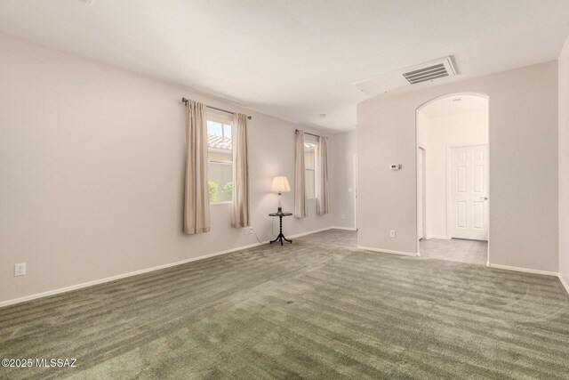 2436 E Desert Pueblo Pass, Green Valley, AZ 85614 - spare room featuring baseboards, arched walkways, dark colored carpet, and visible vents