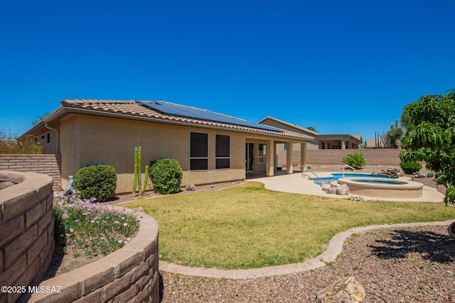 2436 E Desert Pueblo Pass, Green Valley, AZ 85614 - rear view of property with roof mounted solar panels, an outdoor hot tub, a fenced backyard, a lawn, and a patio
