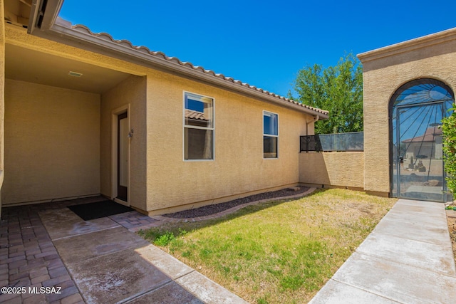 2436 E Desert Pueblo Pass, Green Valley, AZ 85614 - view of side of property with a yard, fence, a patio area, and stucco siding