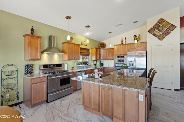 39930 S Mountain Shadow Dr, Tucson, AZ 85739 - kitchen with stainless steel appliances, wall chimney exhaust hood, light marble finish floors, a kitchen island, and light stone counters