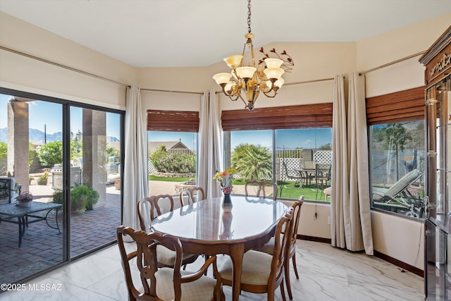 39930 S Mountain Shadow Dr, Tucson, AZ 85739 - dining area with light marble finish flooring, a chandelier, and baseboards