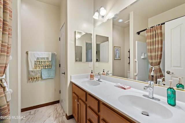 39930 S Mountain Shadow Dr, Tucson, AZ 85739 - full bathroom with double vanity, marble look tile flooring, toilet, baseboards, and a shower with curtain