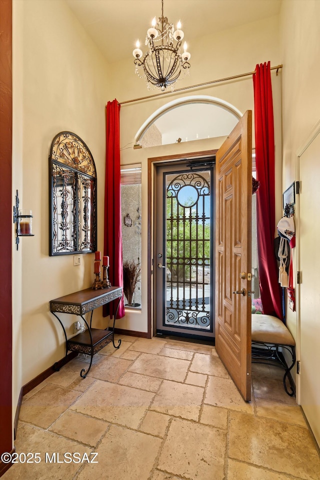 39930 S Mountain Shadow Dr, Tucson, AZ 85739 - foyer entrance featuring stone tile floors, a chandelier, and baseboards