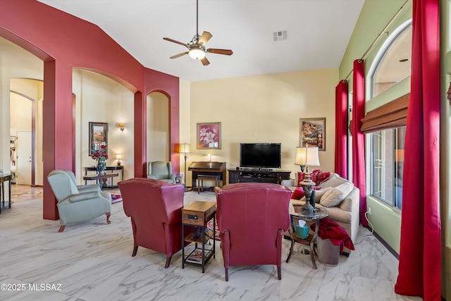 39930 S Mountain Shadow Dr, Tucson, AZ 85739 - living room featuring marble finish flooring, lofted ceiling, ceiling fan, and arched walkways