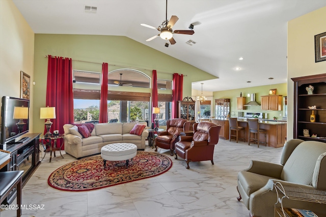 39930 S Mountain Shadow Dr, Tucson, AZ 85739 - living room featuring a ceiling fan, light marble finish flooring, a chandelier, and lofted ceiling