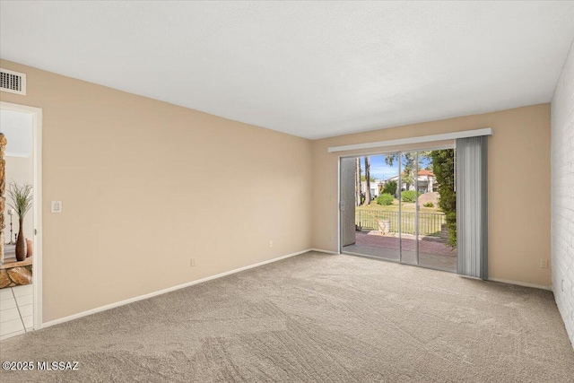 carpeted empty room with baseboards and visible vents