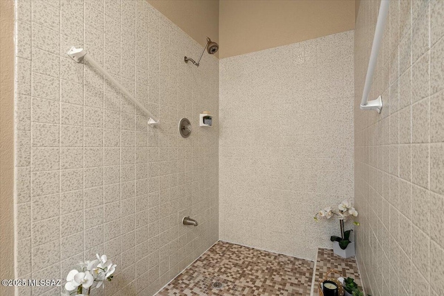 full bath with a tile shower