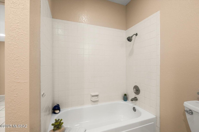 bathroom featuring  shower combination, a textured wall, and toilet