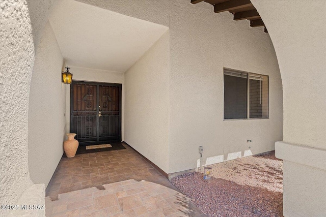 property entrance with stucco siding
