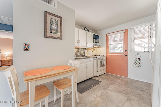 kitchen featuring white cabinets, white appliances, marble finish floor, decorative backsplash, and visible vents