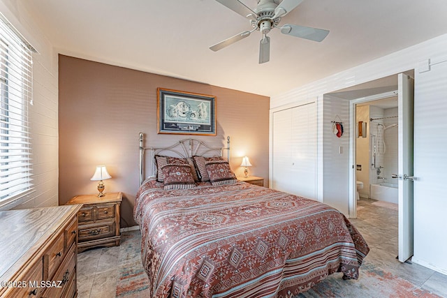 bedroom with a ceiling fan and ensuite bath