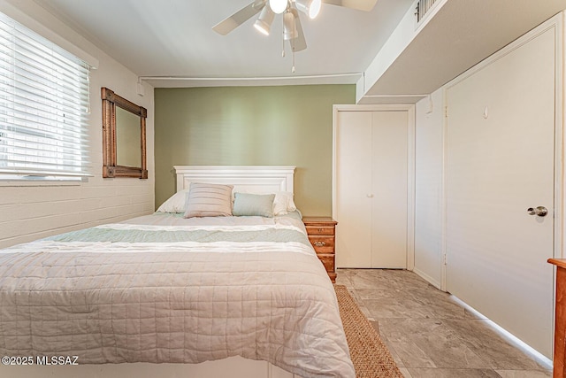 bedroom featuring a ceiling fan, visible vents, and a closet