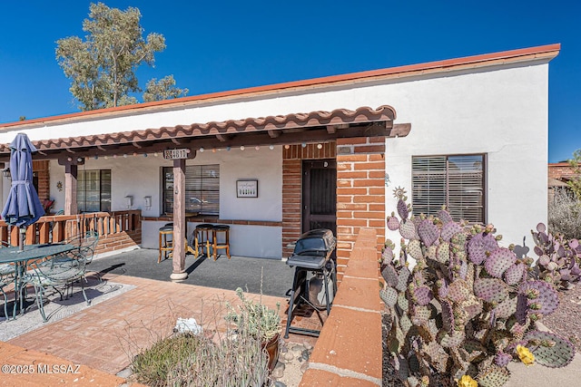 view of front of home with a patio area and stucco siding