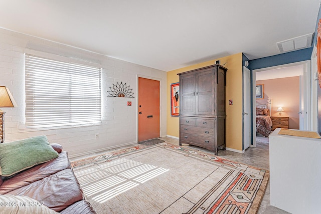 living area featuring baseboards and visible vents