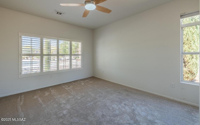 1448 E Mule Train Dr, Oro Valley, AZ 85755 - spare room with carpet floors, ceiling fan, visible vents, and a wealth of natural light