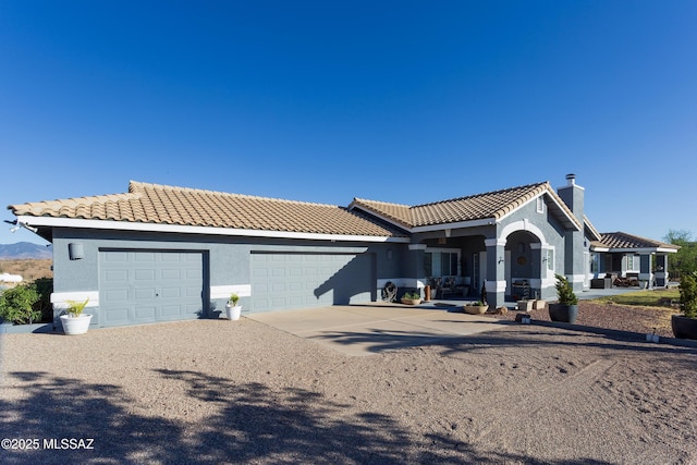 21 Kachina, Rio Rico, AZ 85648 - view of front of house with a garage, stucco siding, driveway, and a tile roof